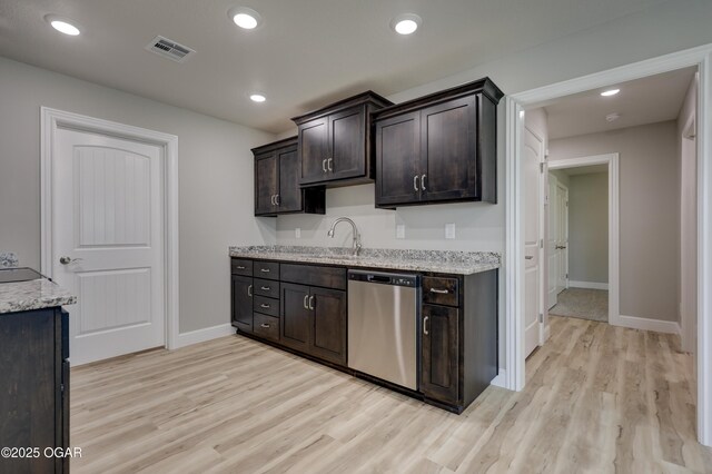 1919 Wisconsin Ave, Joplin, MO 64804 - kitchen featuring stainless steel dishwasher, light wood finished floors, dark brown cabinets, light stone countertops, and recessed lighting