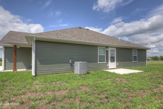 1919 Wisconsin Ave, Joplin, MO 64804 - back of property with a shingled roof, a patio, and a lawn
