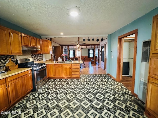 210 S 3 Rd, St, Arma, KS 66712 - kitchen with gas range, under cabinet range hood, a peninsula, a sink, and light countertops