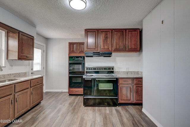 720 Sheridan Ave, Carl Junction, MO 64834 - kitchen featuring range with electric stovetop, under cabinet range hood, light wood finished floors, a sink, and a textured ceiling
