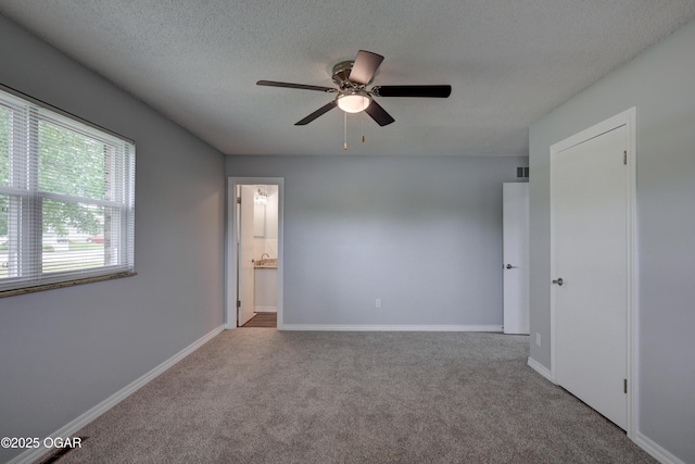 720 Sheridan Ave, Carl Junction, MO 64834 - carpeted spare room featuring a textured ceiling, ceiling fan, and baseboards