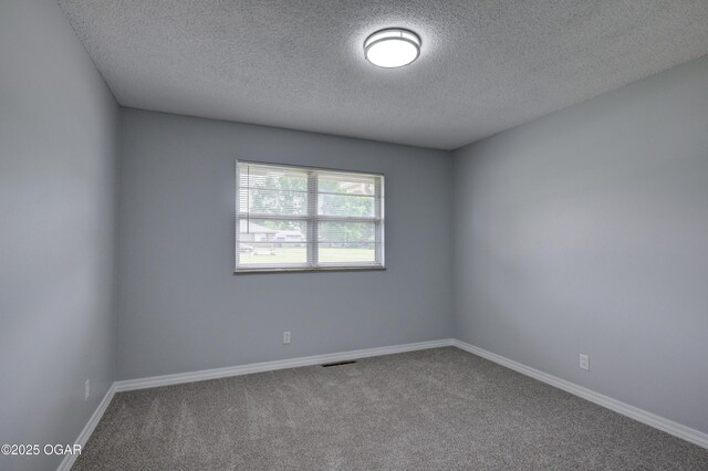 720 Sheridan Ave, Carl Junction, MO 64834 - unfurnished room featuring a textured ceiling, carpet floors, and baseboards