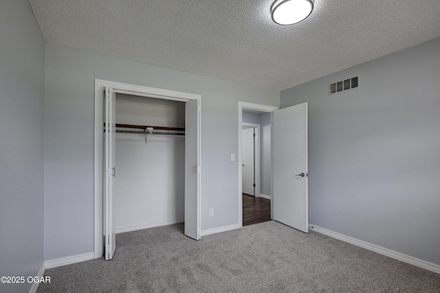 720 Sheridan Ave, Carl Junction, MO 64834 - unfurnished bedroom with carpet floors, a textured ceiling, a closet, and baseboards