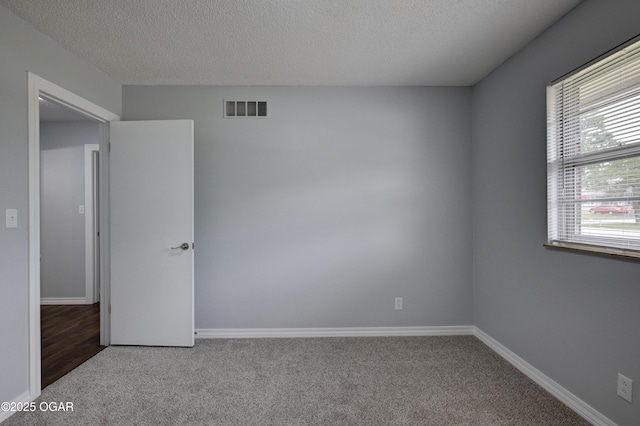 720 Sheridan Ave, Carl Junction, MO 64834 - spare room with carpet floors, a textured ceiling, and baseboards