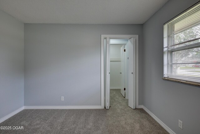 720 Sheridan Ave, Carl Junction, MO 64834 - empty room with carpet flooring and baseboards