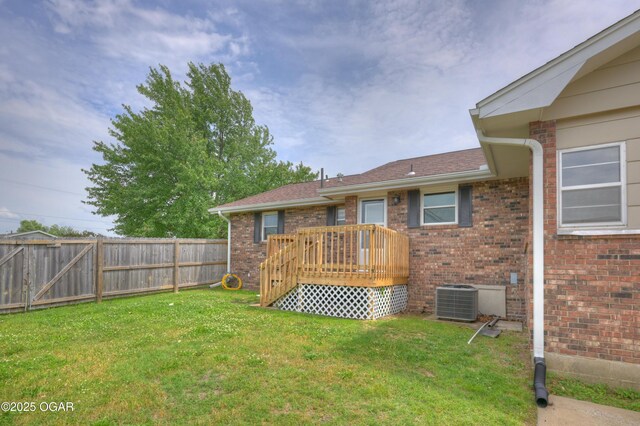 720 Sheridan Ave, Carl Junction, MO 64834 - back of property with central air condition unit, brick siding, a deck, and roof with shingles