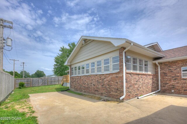 720 Sheridan Ave, Carl Junction, MO 64834 - view of side of home with a patio and brick siding
