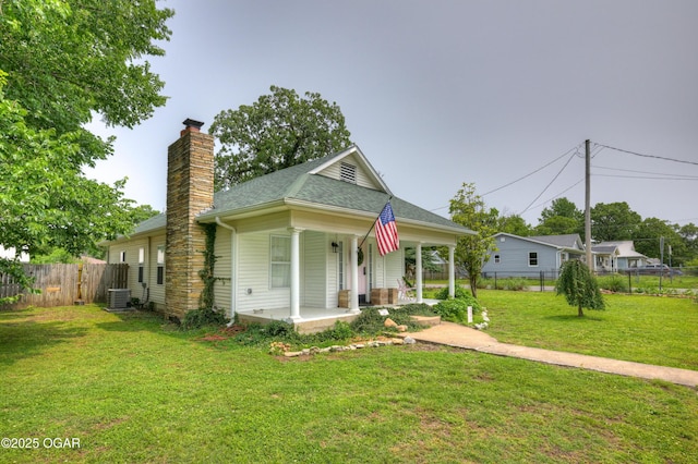 2101 N Florida Ave, Joplin, MO 64801 - bungalow-style home with a chimney, covered porch, central AC, and a shingled roof