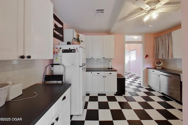 2101 N Florida Ave, Joplin, MO 64801 - kitchen featuring tile patterned floors, dark countertops, freestanding refrigerator, dishwasher, and tasteful backsplash