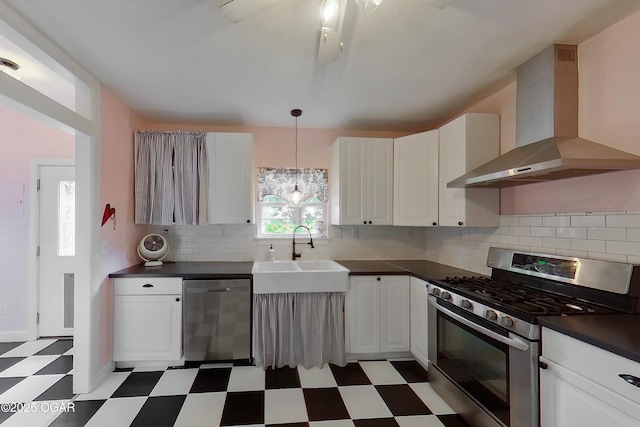2101 N Florida Ave, Joplin, MO 64801 - kitchen with appliances with stainless steel finishes, tile patterned floors, wall chimney range hood, a sink, and dark countertops