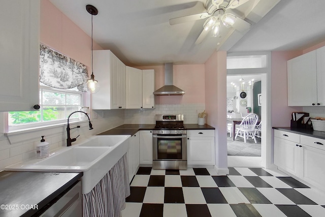 2101 N Florida Ave, Joplin, MO 64801 - kitchen with gas range, wall chimney range hood, light floors, and dark countertops