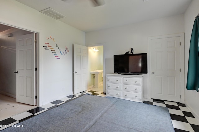 2101 N Florida Ave, Joplin, MO 64801 - bedroom with tile patterned floors, ensuite bath, baseboards, and a sink