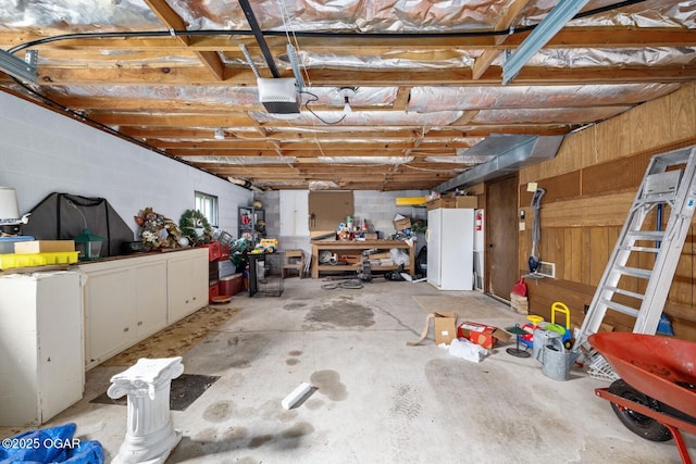 802 Hawthorne Dr, Neosho, MO 64850 - garage with a garage door opener and freestanding refrigerator