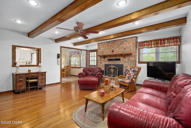 802 Hawthorne Dr, Neosho, MO 64850 - living room with wood finished floors, baseboards, ceiling fan, recessed lighting, and a brick fireplace