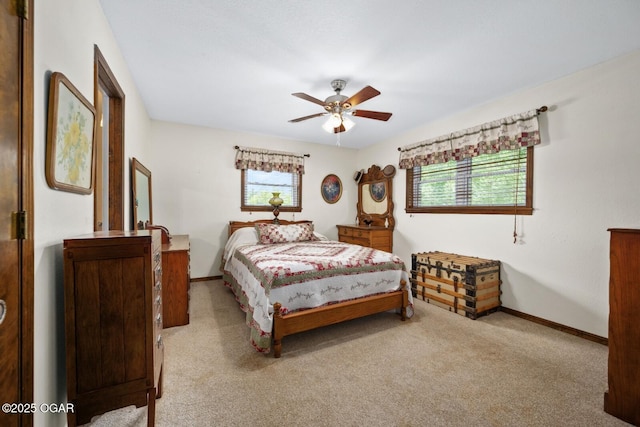 802 Hawthorne Dr, Neosho, MO 64850 - carpeted bedroom featuring multiple windows, baseboards, and ceiling fan
