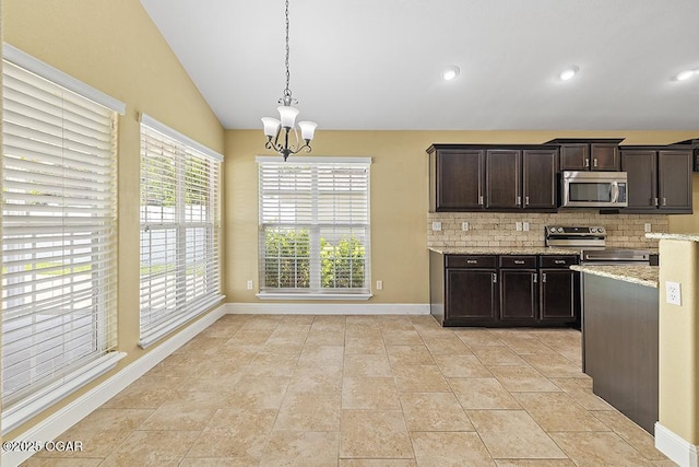 111 Zachary Ln, Carl Junction, MO 64834 - kitchen with appliances with stainless steel finishes, decorative backsplash, baseboards, vaulted ceiling, and a chandelier