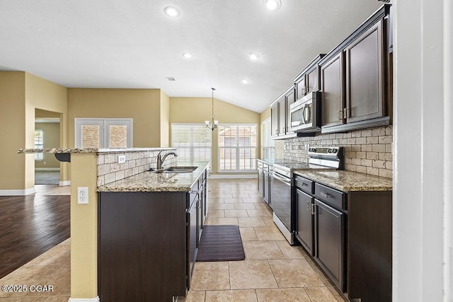 111 Zachary Ln, Carl Junction, MO 64834 - kitchen featuring appliances with stainless steel finishes, a sink, decorative backsplash, baseboards, and lofted ceiling