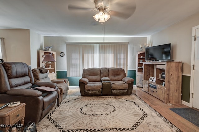 1418 Forest St, Carthage, MO 64836 - living room featuring a ceiling fan, wood finished floors, and baseboards