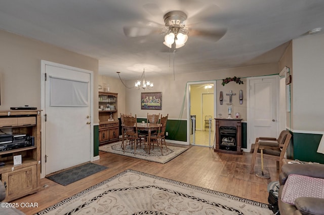 1418 Forest St, Carthage, MO 64836 - dining room with ceiling fan, wood finished floors, a chandelier, and baseboards
