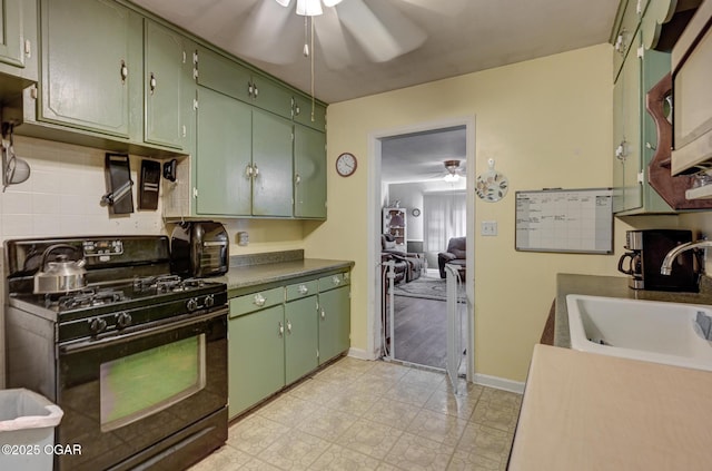 1418 Forest St, Carthage, MO 64836 - kitchen with black gas range oven, a ceiling fan, and green cabinets