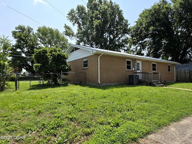 202 S Mckinley Ave, Joplin, MO 64801 - view of front facade with brick siding, a deck, and cooling unit