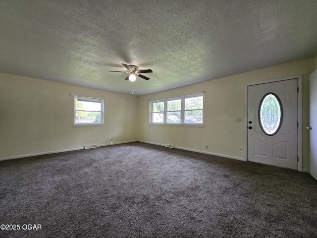 202 S Mckinley Ave, Joplin, MO 64801 - carpeted entrance foyer with a textured ceiling, plenty of natural light, a ceiling fan, and baseboards