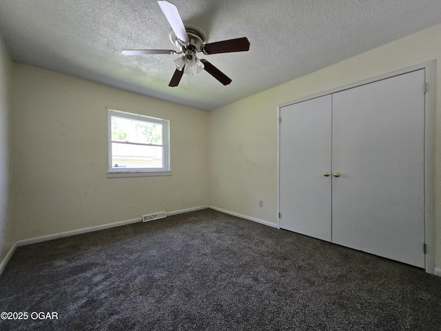 202 S Mckinley Ave, Joplin, MO 64801 - unfurnished bedroom with a textured ceiling, dark carpet, a ceiling fan, baseboards, and a closet