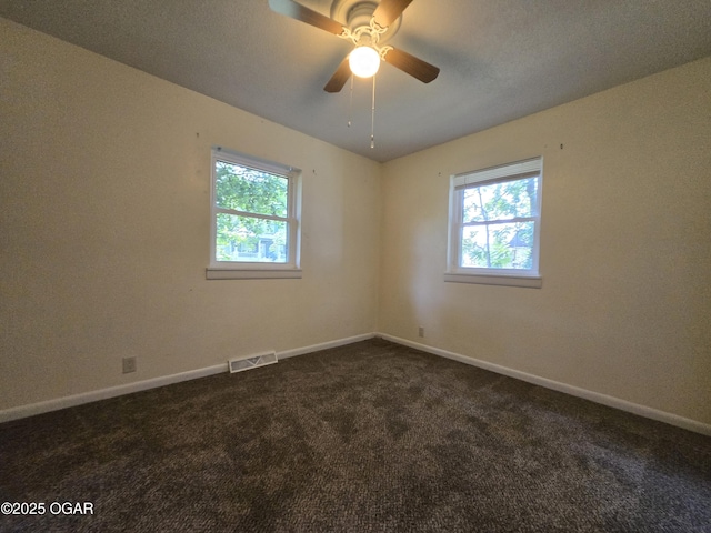 202 S Mckinley Ave, Joplin, MO 64801 - empty room featuring plenty of natural light, dark colored carpet, and baseboards
