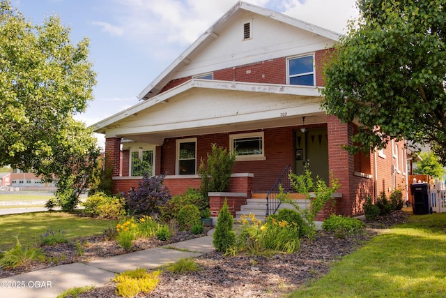 702 W Daugherty St, Webb City, MO 64870 - traditional style home with brick siding, a front yard, and covered porch