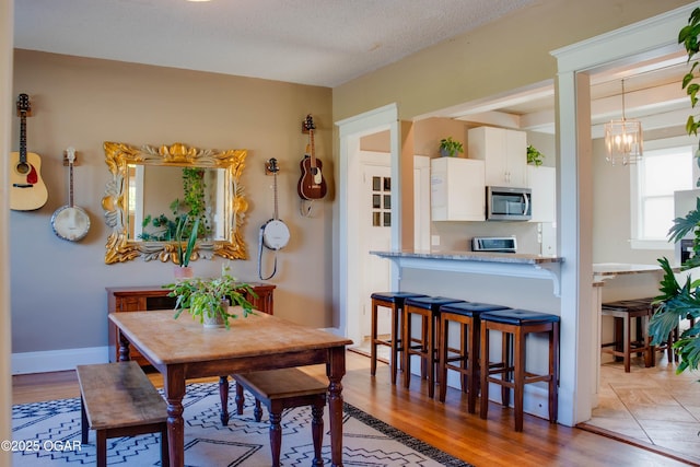 702 W Daugherty St, Webb City, MO 64870 - dining space with a chandelier and light wood-style floors