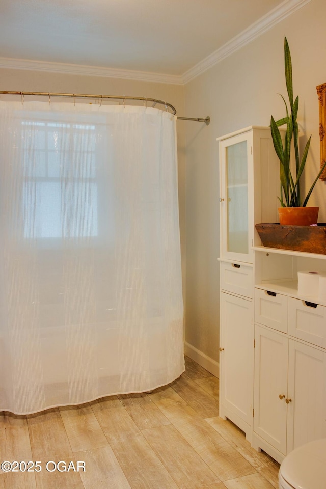 702 W Daugherty St, Webb City, MO 64870 - bathroom with wood finished floors, toilet, crown molding, and curtained shower