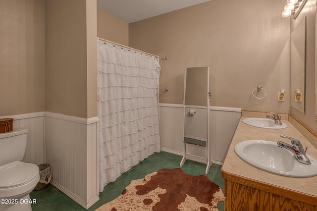 408 W Walton Ave, Carl Junction, MO 64834 - bathroom with wainscoting, toilet, double vanity, and curtained shower