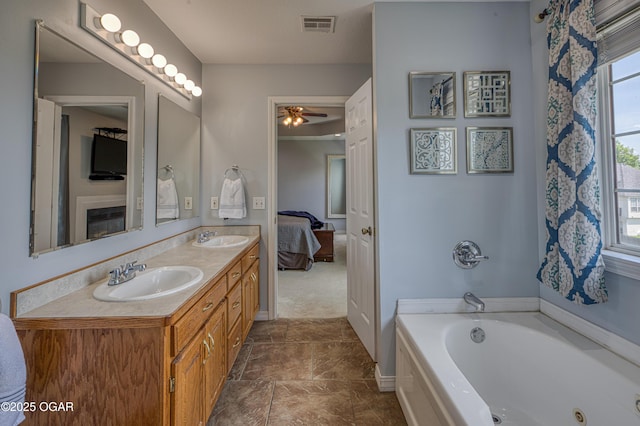 408 W Walton Ave, Carl Junction, MO 64834 - full bathroom with double vanity, a whirlpool tub, ceiling fan, and ensuite bathroom