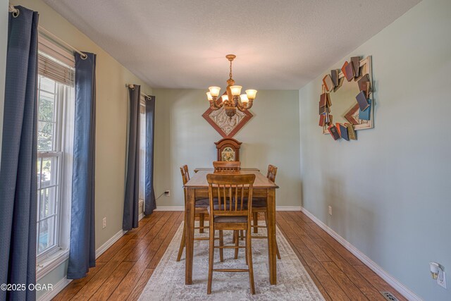 408 W Walton Ave, Carl Junction, MO 64834 - dining area with a chandelier, hardwood / wood-style floors, and baseboards