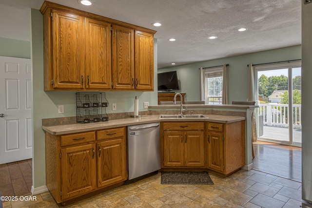 408 W Walton Ave, Carl Junction, MO 64834 - kitchen featuring dishwasher, a sink, a peninsula, brown cabinetry, and light countertops