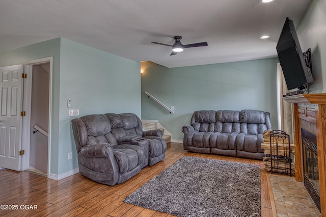408 W Walton Ave, Carl Junction, MO 64834 - living room with light wood-type flooring, a ceiling fan, a tile fireplace, recessed lighting, and baseboards