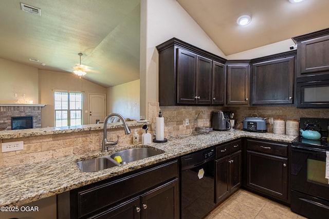 102 Zachary Ln, Carl Junction, MO 64834 - kitchen featuring black appliances, vaulted ceiling, a sink, tasteful backsplash, and light stone countertops
