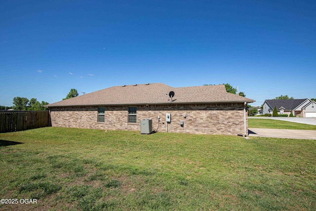 102 Zachary Ln, Carl Junction, MO 64834 - rear view of property with central AC unit, a shingled roof, and brick siding
