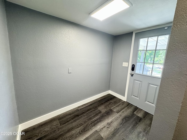 1326 E 14th St, Pittsburg, KS 66762 - doorway to outside featuring dark wood finished floors, baseboards, and a textured wall