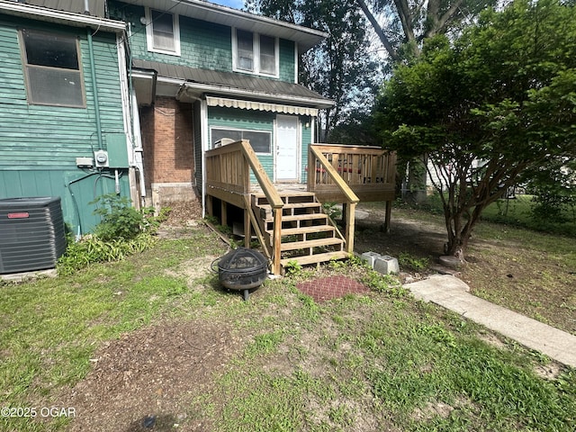 206 S Connor Ave, Joplin, MO 64801 - back of house with central air condition unit, a wooden deck, a fire pit, and stairs