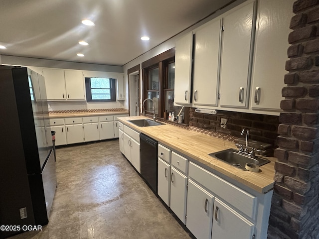 206 S Connor Ave, Joplin, MO 64801 - kitchen featuring freestanding refrigerator, a sink, black dishwasher, tasteful backsplash, and recessed lighting