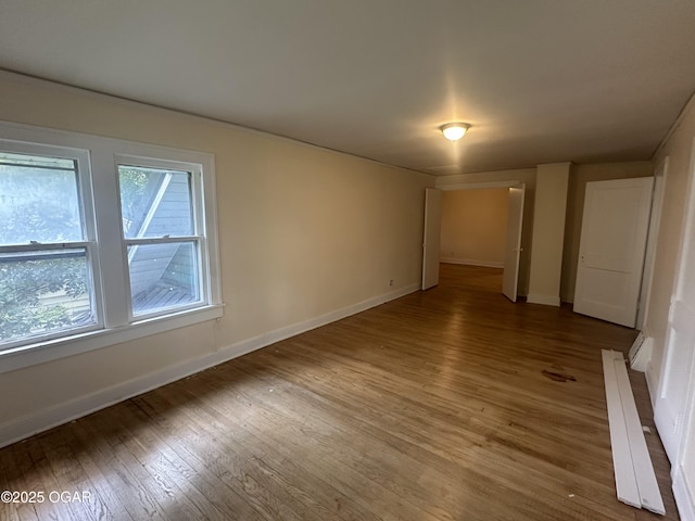 206 S Connor Ave, Joplin, MO 64801 - empty room featuring wood finished floors, baseboards, and a baseboard heating unit