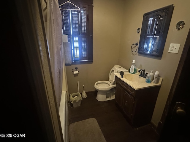 206 S Connor Ave, Joplin, MO 64801 - bathroom featuring vanity, toilet, baseboards, shower / tub combo, and wood finished floors