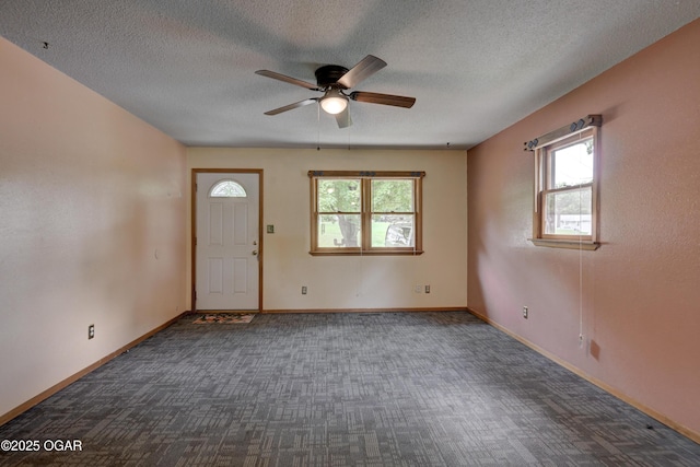 1507 Hilldale Dr, Neosho, MO 64850 - foyer entrance featuring a ceiling fan, dark colored carpet, a textured ceiling, and baseboards