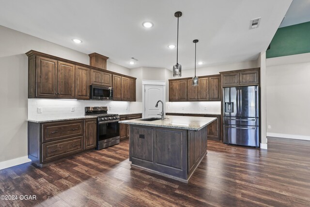216 Timber Trail Dr, Joplin, MO 64804 - kitchen with appliances with stainless steel finishes, a sink, dark brown cabinets, baseboards, and dark wood-style flooring