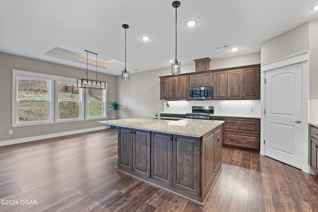 216 Timber Trail Dr, Joplin, MO 64804 - kitchen with stainless steel appliances, a sink, dark wood-style flooring, dark brown cabinets, and a kitchen island with sink