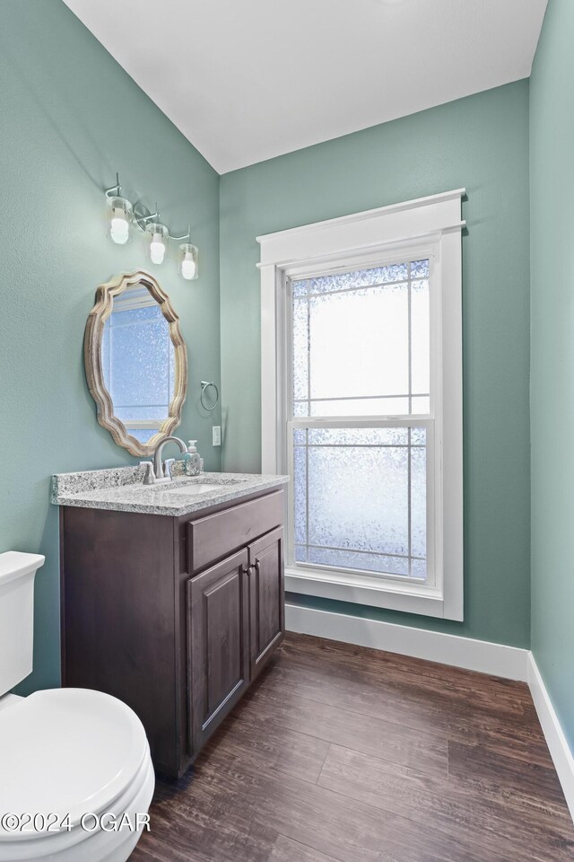 216 Timber Trail Dr, Joplin, MO 64804 - half bath with toilet, vanity, wood finished floors, and baseboards