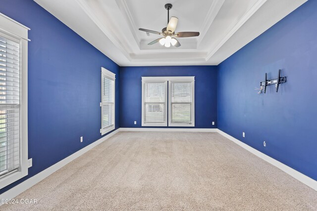 216 Timber Trail Dr, Joplin, MO 64804 - empty room featuring carpet floors, ceiling fan, a tray ceiling, ornamental molding, and baseboards