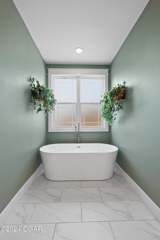 216 Timber Trail Dr, Joplin, MO 64804 - bathroom with baseboards, a freestanding tub, marble look tiles, and recessed lighting