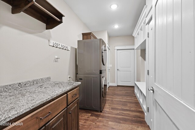 216 Timber Trail Dr, Joplin, MO 64804 - laundry room featuring stacked washer / drying machine, dark wood-type flooring, cabinet space, and recessed lighting